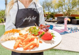 Party Host Helper holding food tray